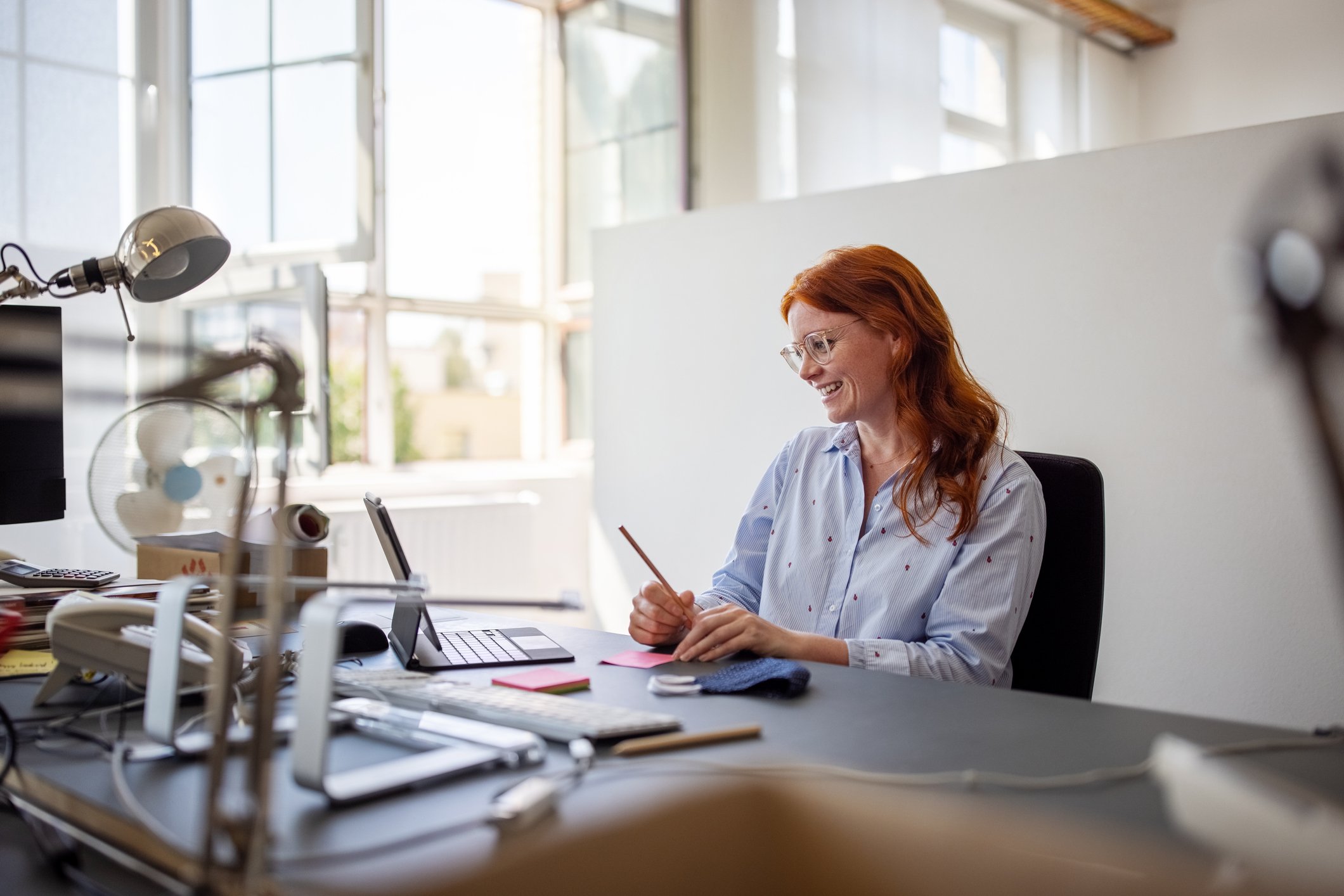 Businesswoman having teleconference from her office desk 