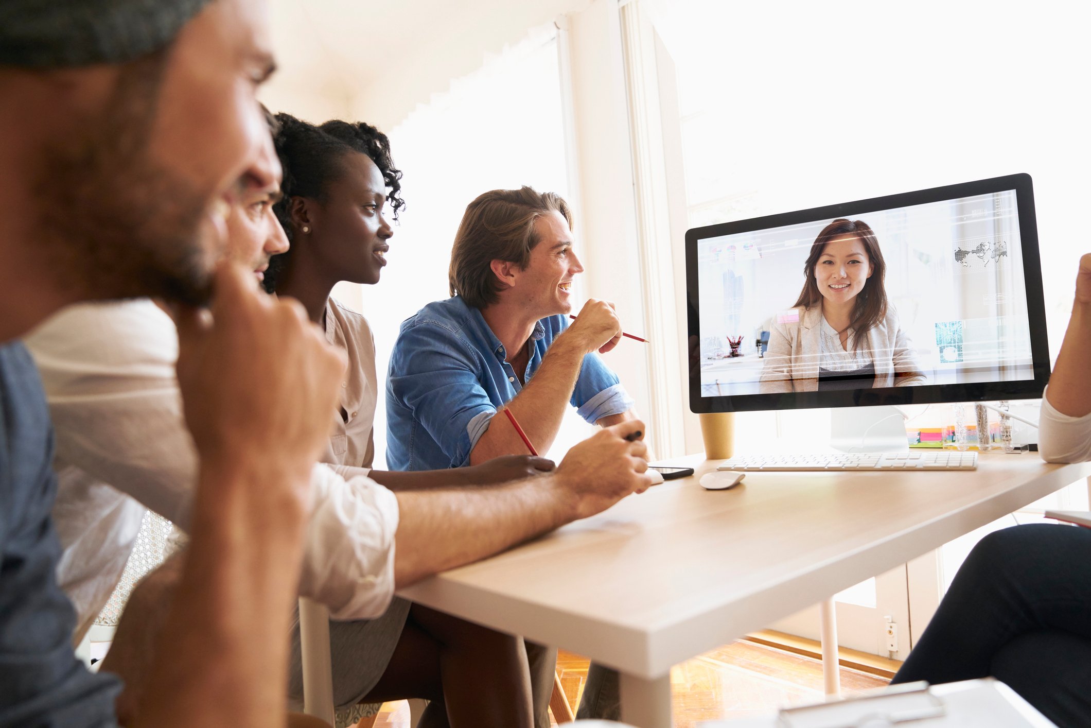 People talking on video conference in office