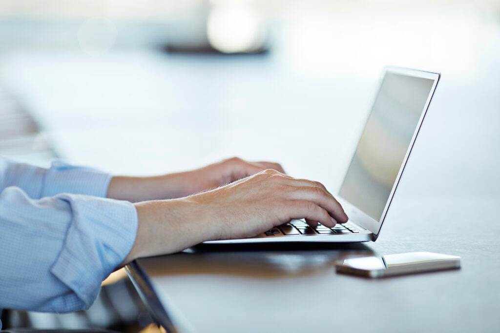 Man typing on laptop