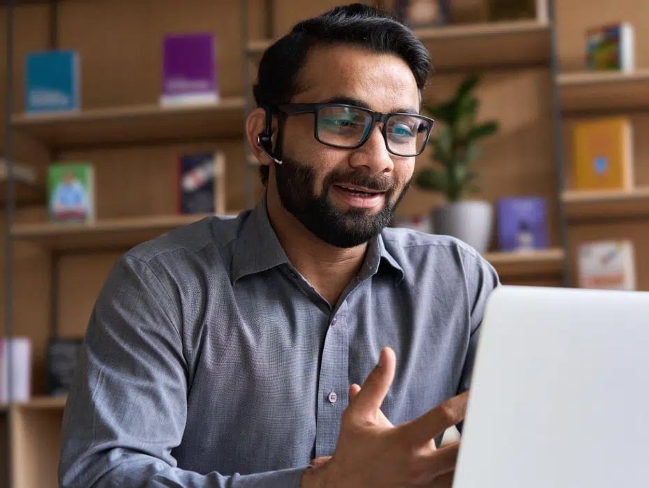 A Man Attending Online Meeting on His Desk