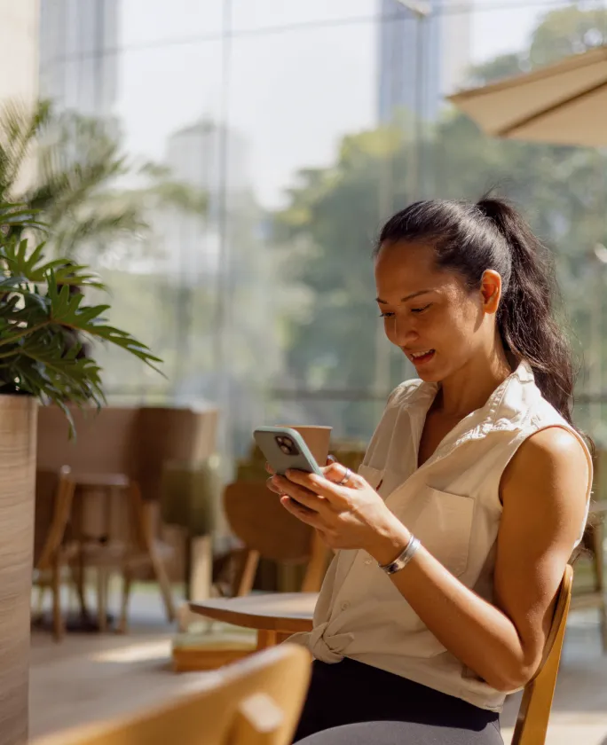 A woman using her mobile phone to check messages about her virtual fundraising campaign