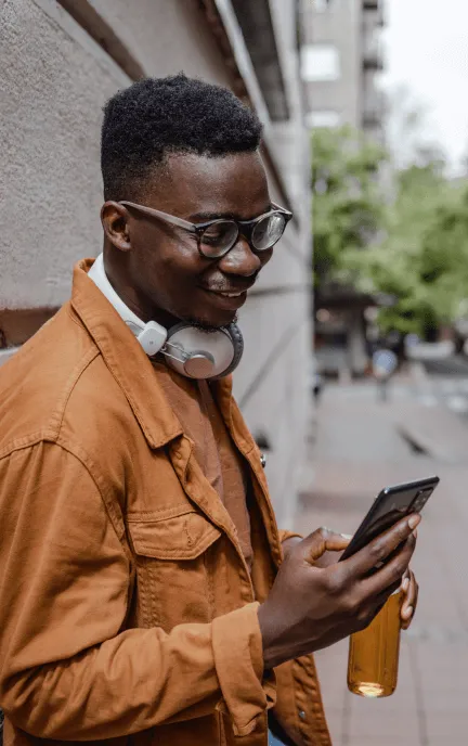 A man checking his phone while outdoors