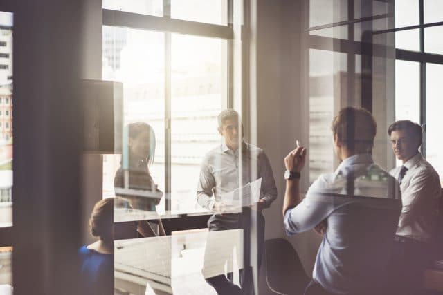 business people having discussion in board room