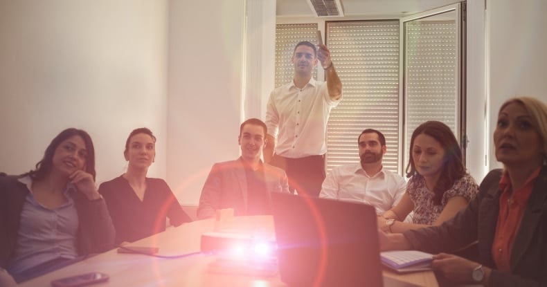 public sector business team in meeting room watching video presentation