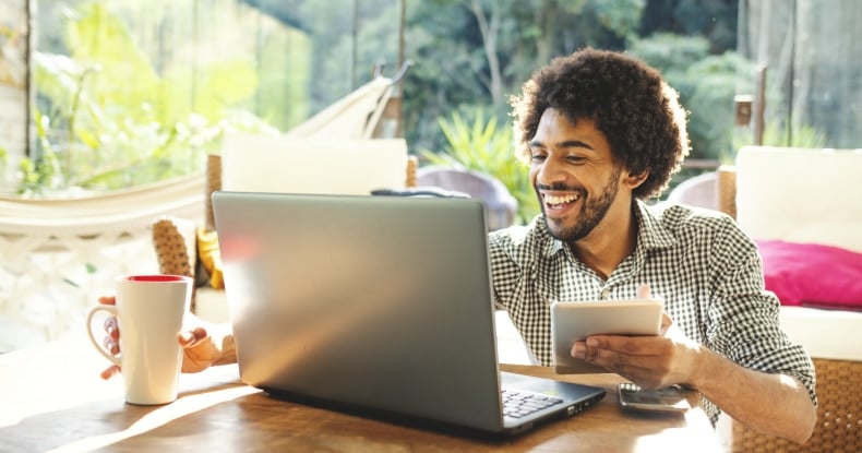 man using laptop in the living room to work from home