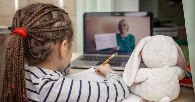 schoolgirl studying online lesson at home, social distance during quarantine, online education