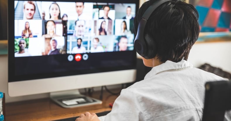 Woman working at home having a video conference with colleagues