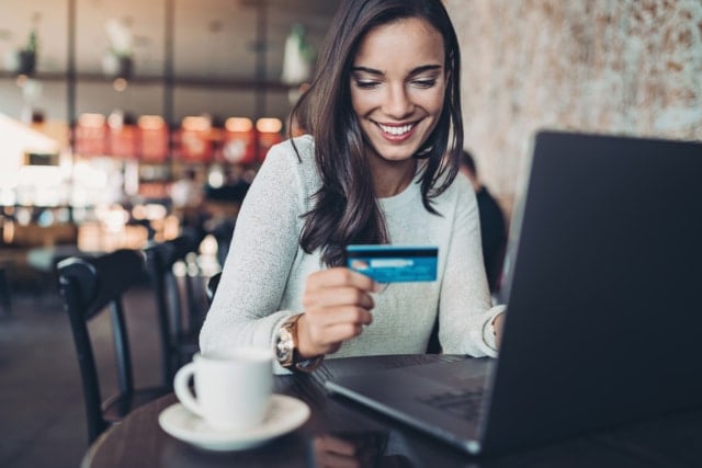 Smiling woman making a credit card purchase-774