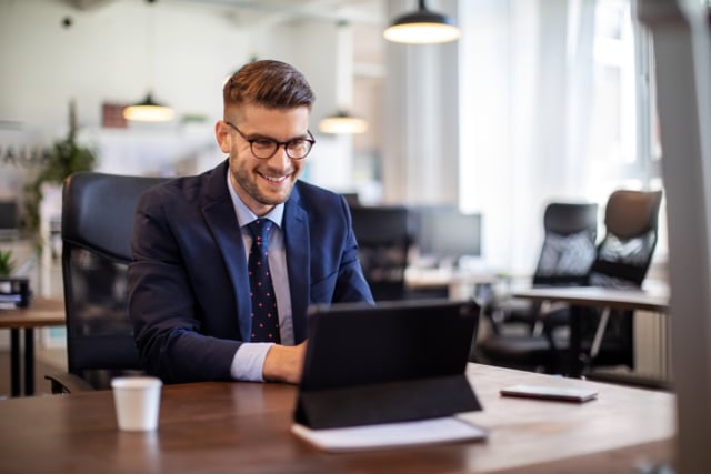 Businessman having online briefing with team at office-247