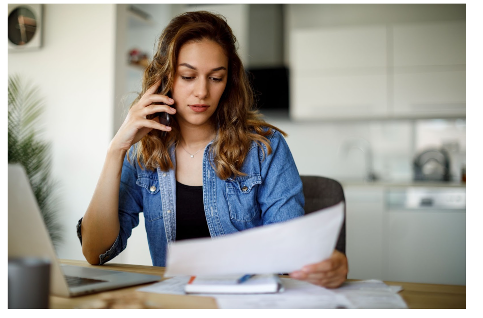 A woman is making a call from her phone