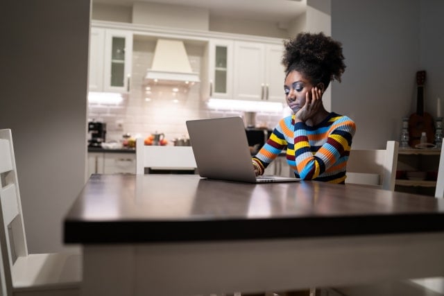 african woman working in isolation in home in a state of emergency