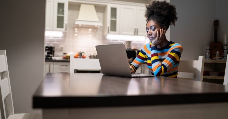 african woman working in isolation in home in a state of emergency