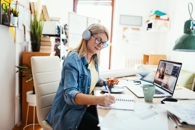 mature businesswoman working remotely and having video call with colleagues