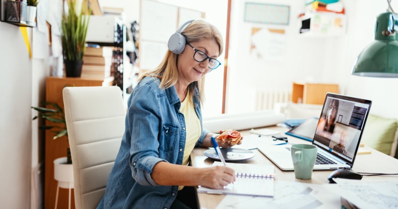 mature businesswoman working remotely and having video call with colleagues