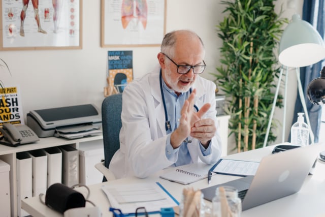 doctor giving online consultation to his patient