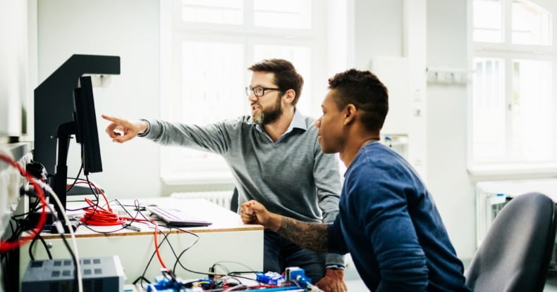 Engineering Tutor Helping Student During Teaching Session-724