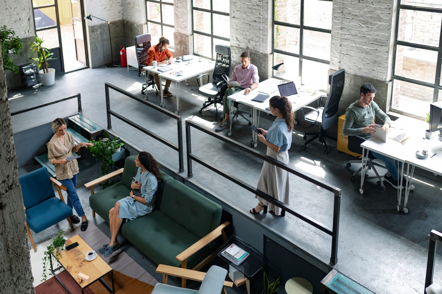 Group of young entrepreneurs freelancers working at a spacious open space office