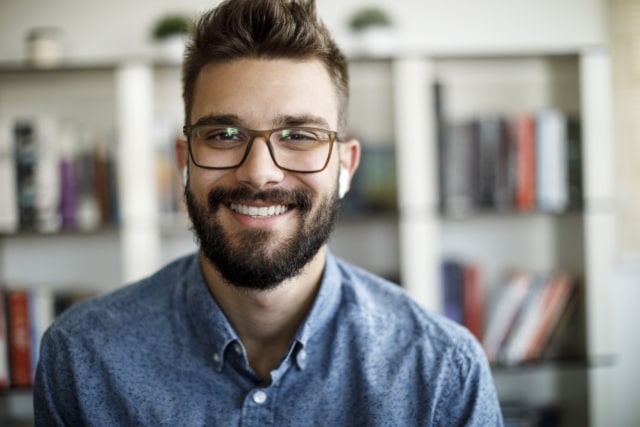 smiling man receptionist answering a call online