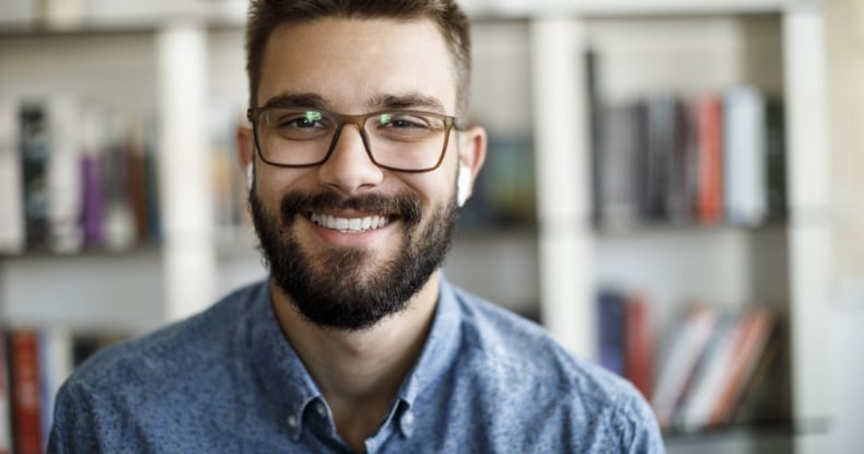 smiling man receptionist answering a call online