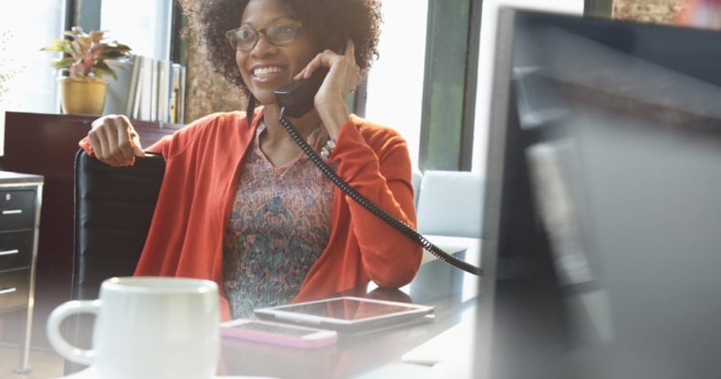 woman on the phone in the office at her desk.jpg