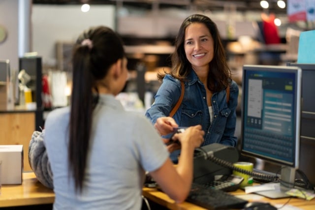 Female Customer Making A Contactless Payment with Credit Card | RingCentral UK