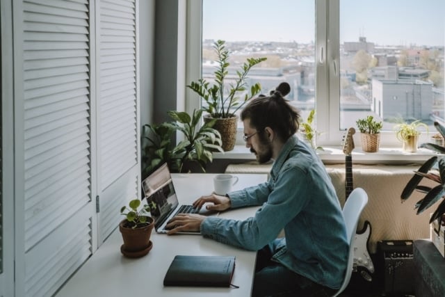 young-man-with-beard-sitting-at-the-table-and-using-laptop-freelance-work-from-home-in-quarantine_t20_9k9e16-336