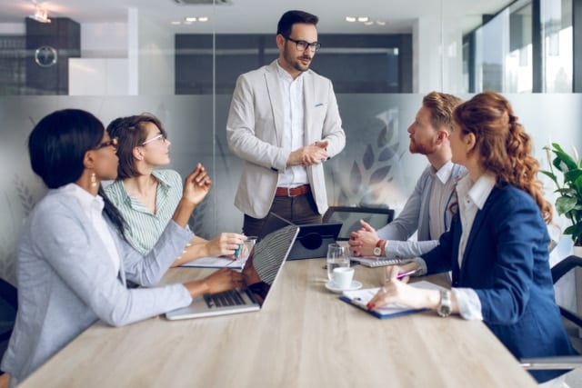 Young businessman discussing sale analysis with colleagues-578