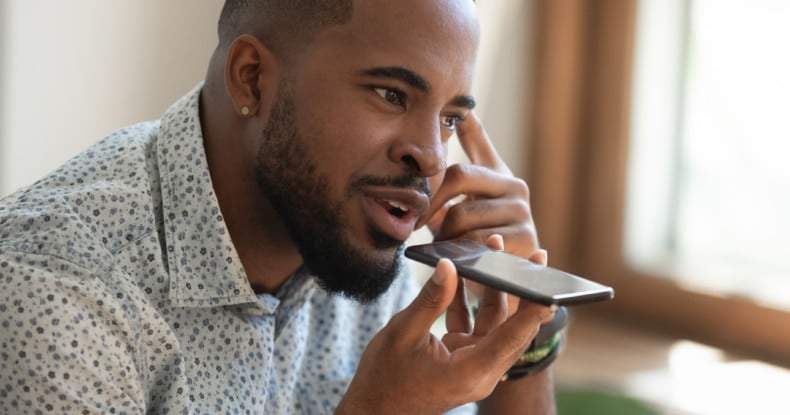 Close up man using mobile phone to contact a call centre for customer service