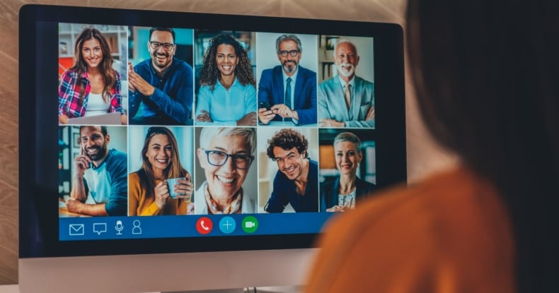 Woman in a video conference with her coworkers while working from home