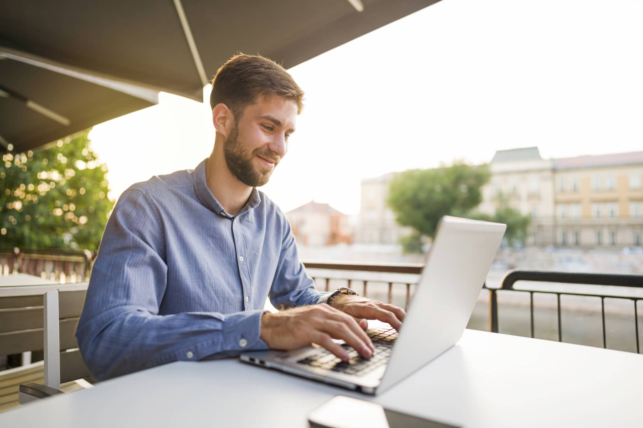 businessman working with his laptop on the nice summer day outside