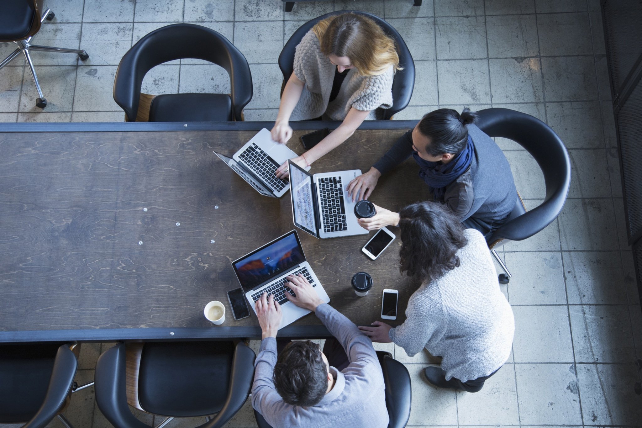 Business people in office meeting using laptops-897