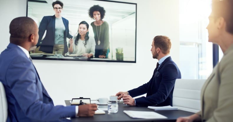 a diverse team of colleagues having a free conference call in a modern office