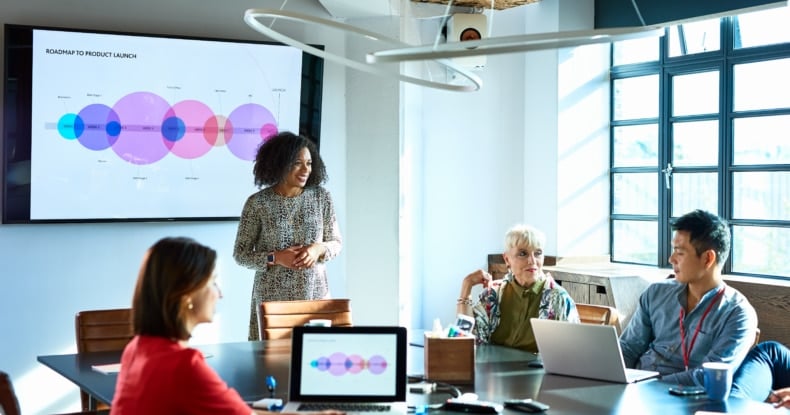 Attractive businesswoman heads strategy meeting in board room-914