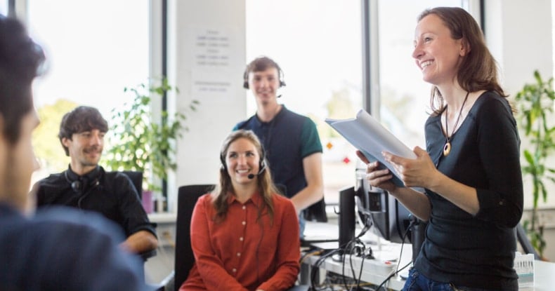 Smiling businesswoman discussing with colleagues in meeting-733