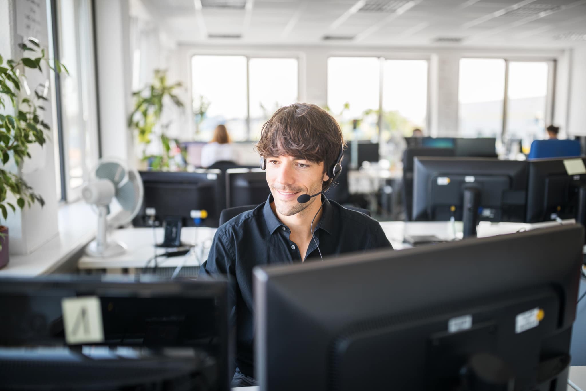 Customer service representative using computers in office-844