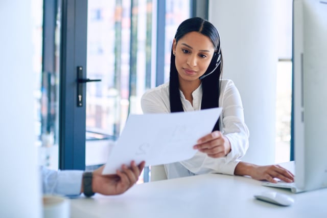 A call centre agent receiving the script of common customer queries