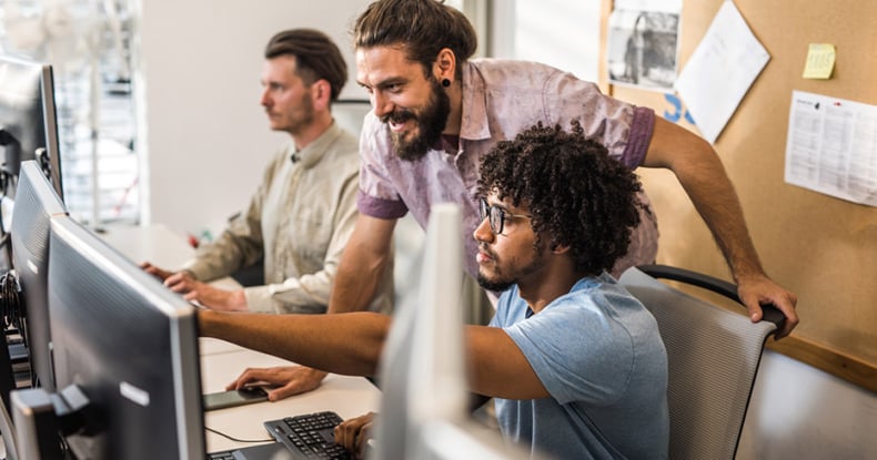 Male programmers cooperating while working on computer codes in the office.-949