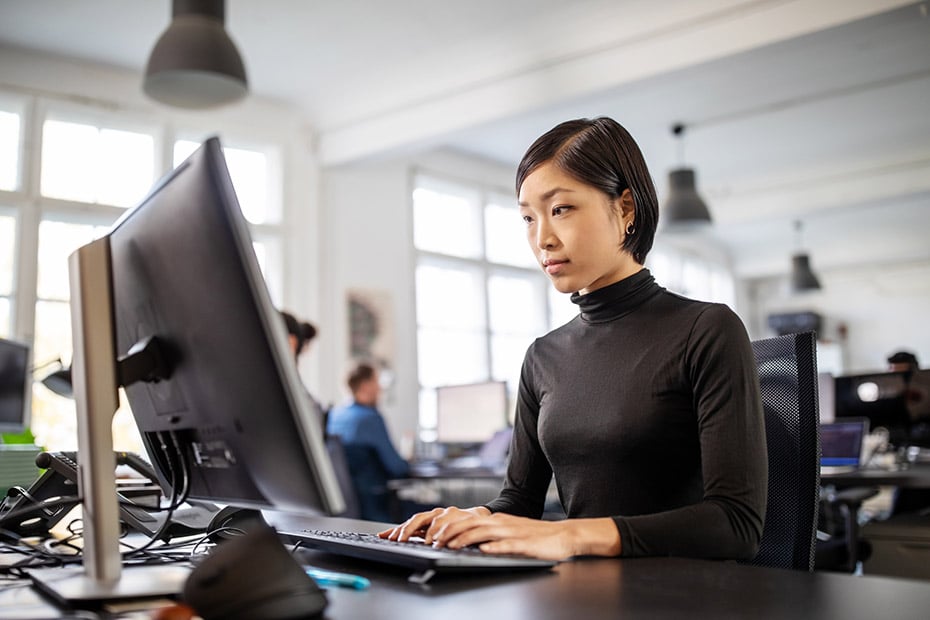 Woman busy working at her desk in open plan office-862