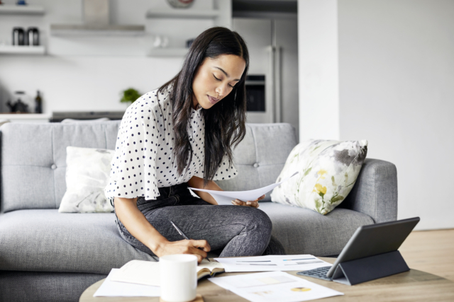 Woman analyzing documents while sitting at home-846