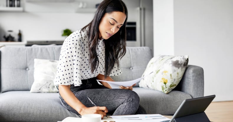 Woman analyzing documents while sitting at home-846