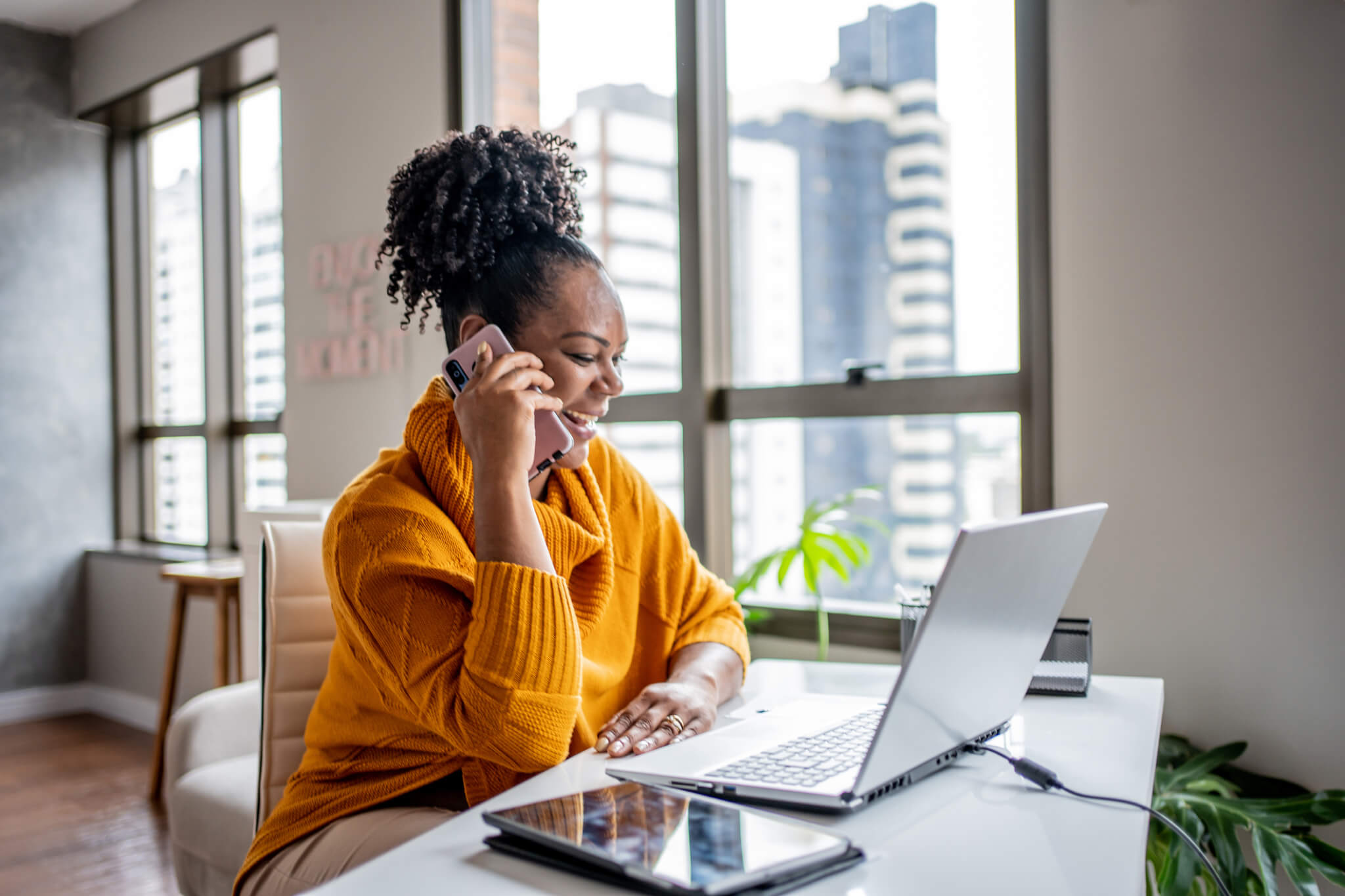 Black woman talking on the phone at home-972