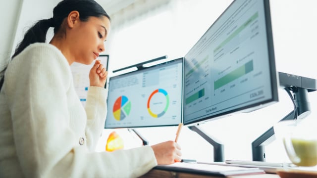 Woman with back pain working at standing desk home office-325