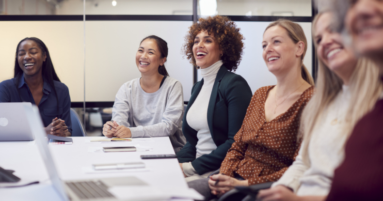 Line Of Businesswomen In Modern Office Listening To Presentation By Colleague-647