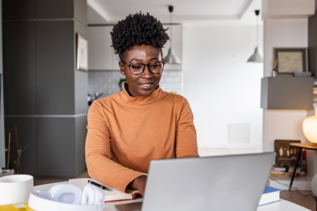 A young Black woman is working on the laptop-936