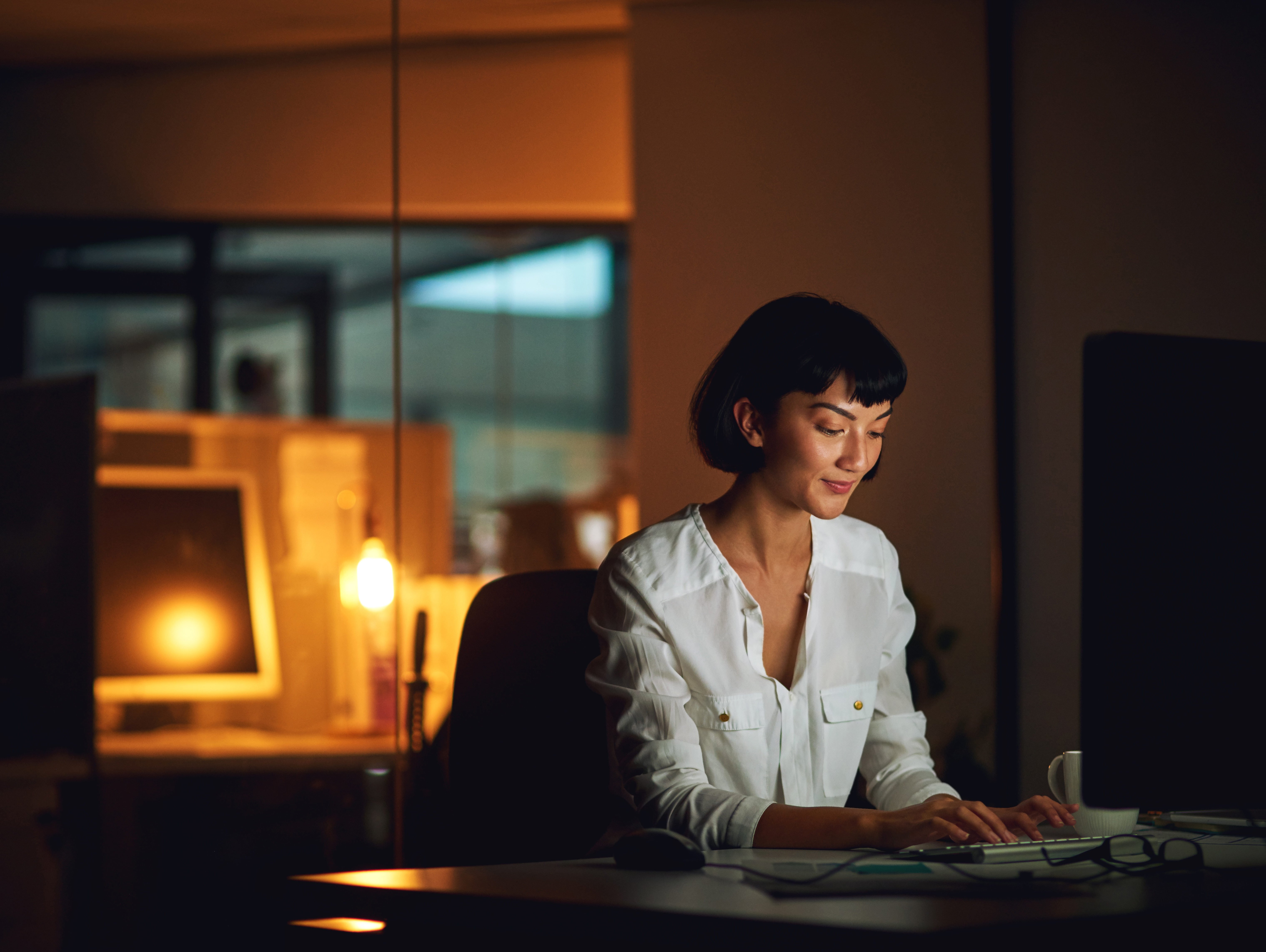 Woman on computer in a dimly lit room