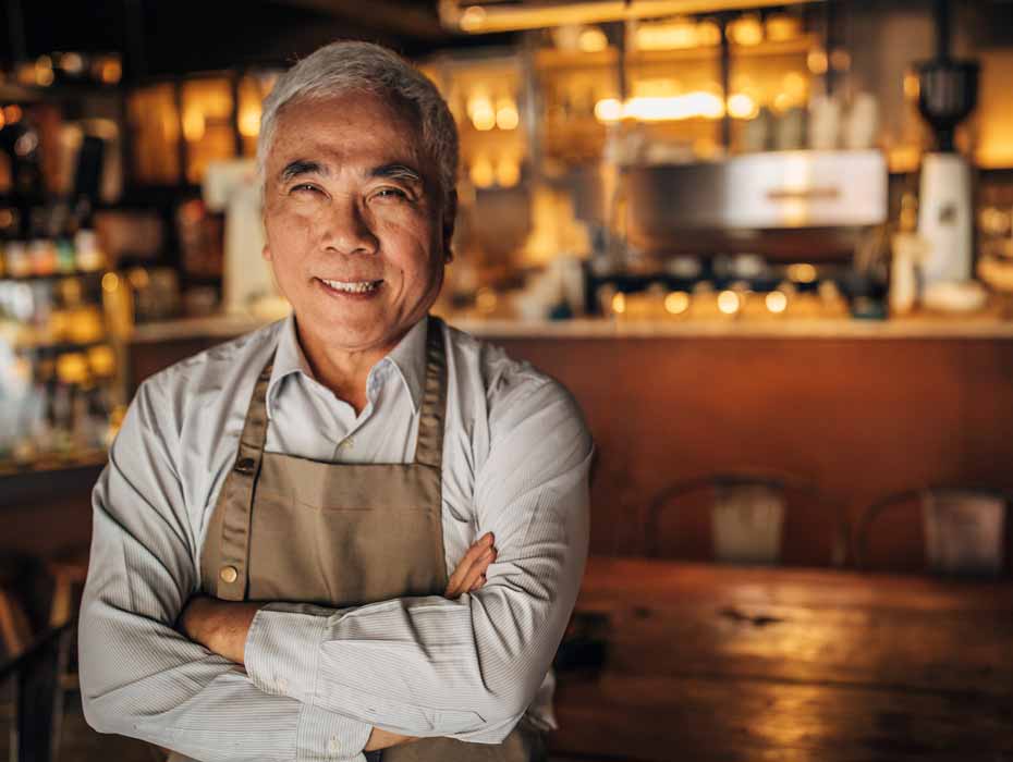 A smiling restaurant business owner ready to welcome customers