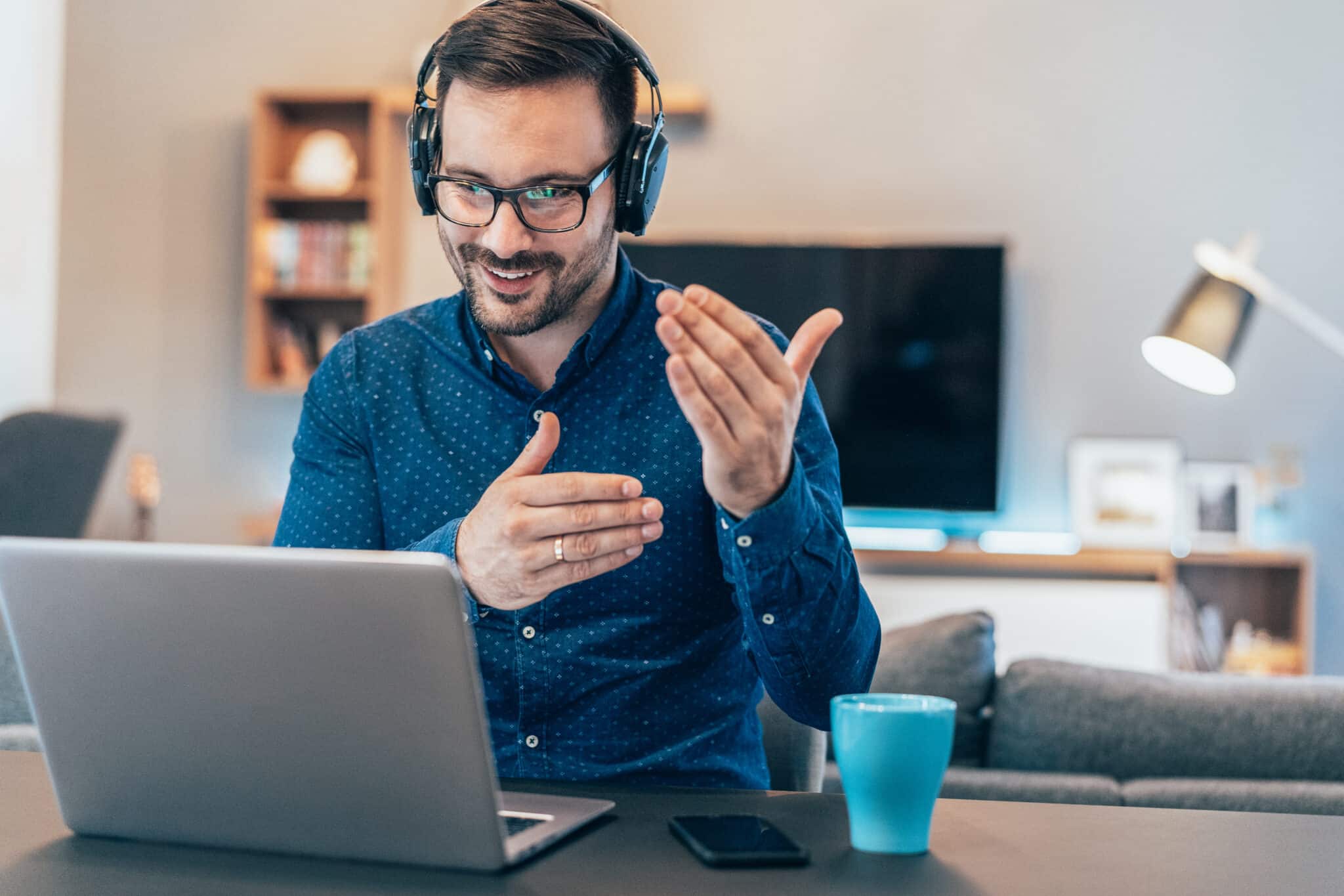 A worker at their desk taking part in a video call; perhaps using a Zoom alternative