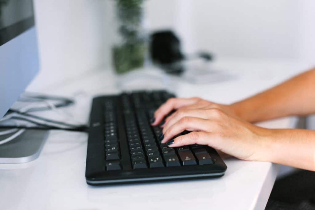 woman typing on keyboard