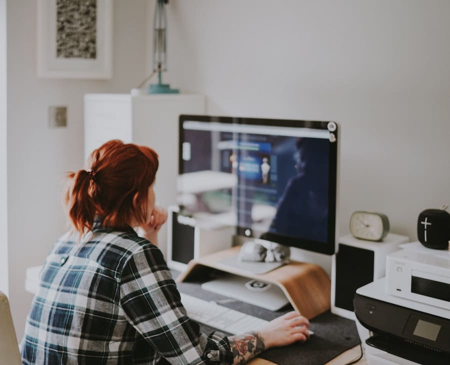 Woman working from home on desktop computer