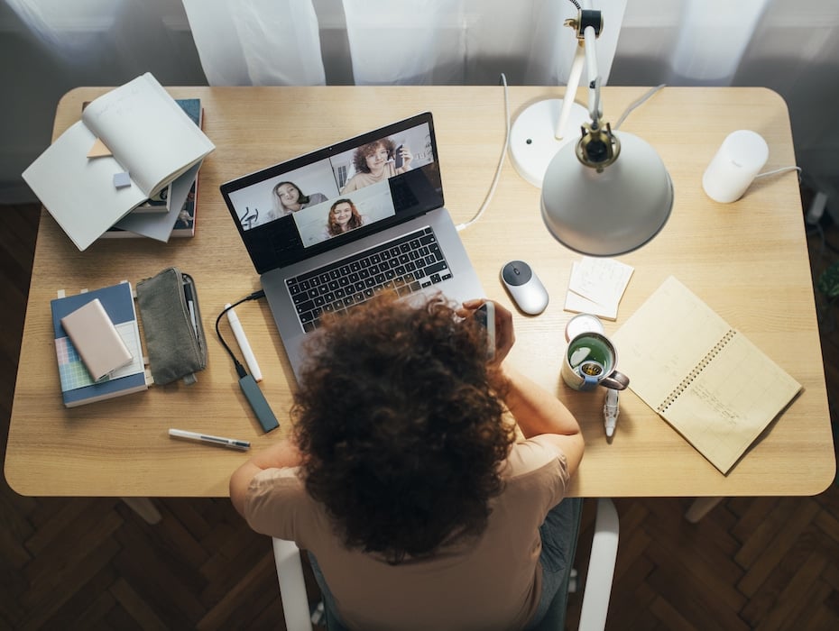 An employee on a video call on their laptop; perhaps utilizing a cloud communications platform.